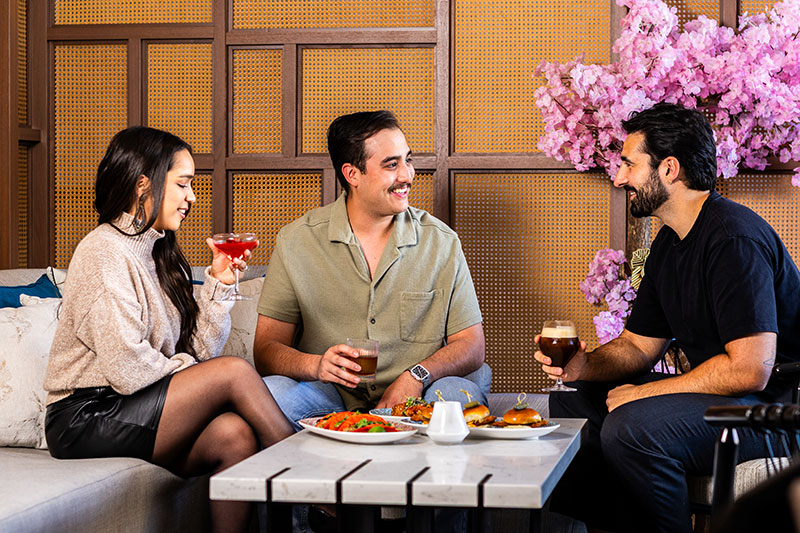 3 friends enjoying cocktails at High Praise